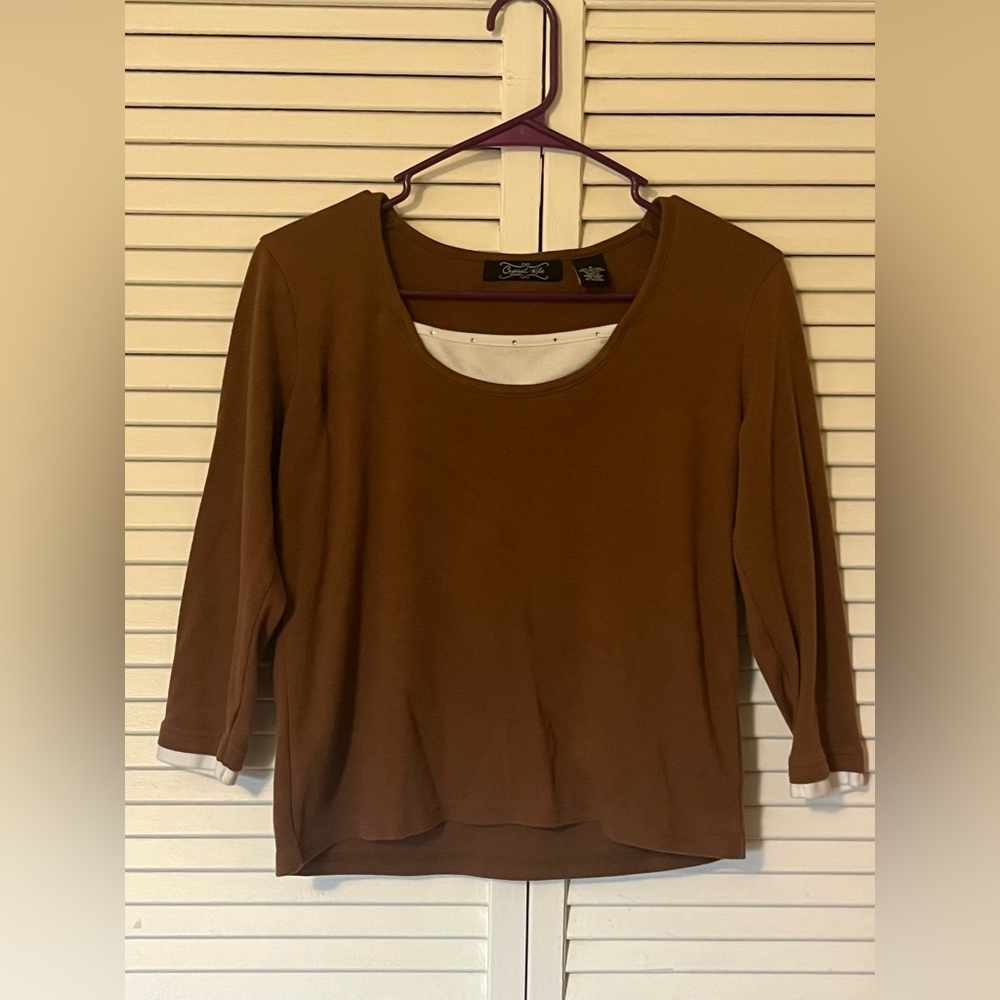 Brown 3 quarter sleeved top with white trim detail and rhinestone embellishments